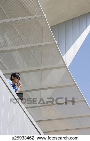 Stock Image - Businesswoman Using Cell Phone. Fotosearch