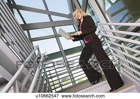 Businesswoman with Laptop on Stairs View Large Photo Image Stock Photo - Businesswoman with Laptop on Stairs. Fotosearch