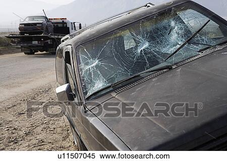 Stock Photography - Car with broken windshield on roadside. Fotosearch