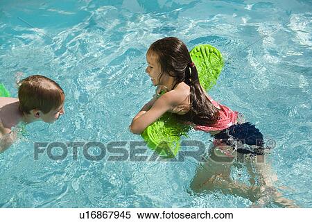 Stock Photography - Children Playing With Float Toys in Swimming Pool. Fotosearch