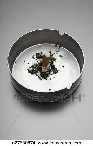 Picture - Cigarette in ashtray. Fotosearch