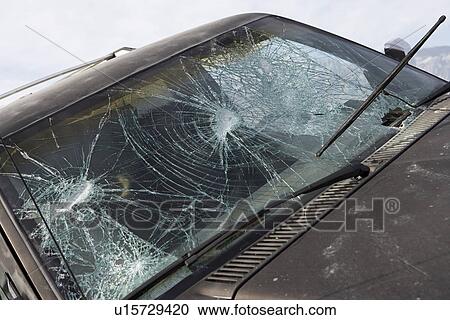 Stock Image - Close-up of car with broken windshield. Fotosearch