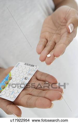Close-up of woman's hands holding pills View Large Photo Image Picture - Close-up of woman's hands holding pills. Fotosearch