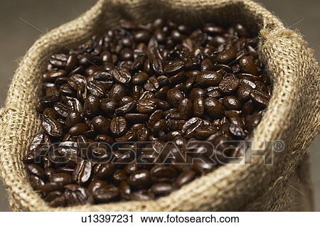 Stock Image - Coffee beans in sack, close-up. Fotosearch