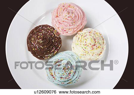 Colourful cupcakes on plate, view from above View Large Photo Image Stock Photograph - Colourful cupcakes on plate, view from above. Fotosearch