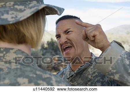 Stock Image - Commander yelling at female soldier. Fotosearch