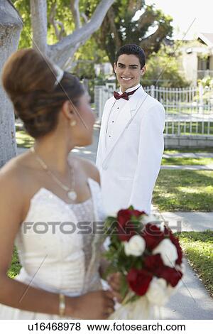 Stock Photo - Couple (13-15) in garden at Quinceanera (selective focus). Fotosearch