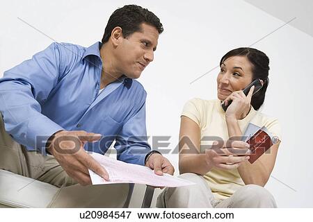 Stock Photo - Couple Calling About Credit Card Bill. Fotosearch