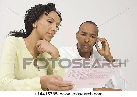 Couple Dealing with a Bill View Large Photo Image Stock Photography - Couple Dealing with a Bill. Fotosearch