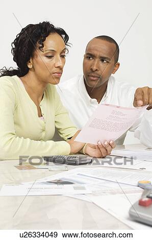 Stock Photo - Couple Discussing a Bill. Fotosearch