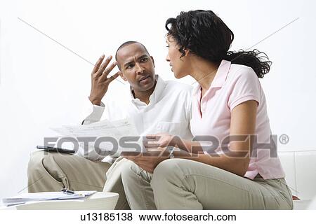Stock Photo - Couple Discussing Bills. Fotosearch