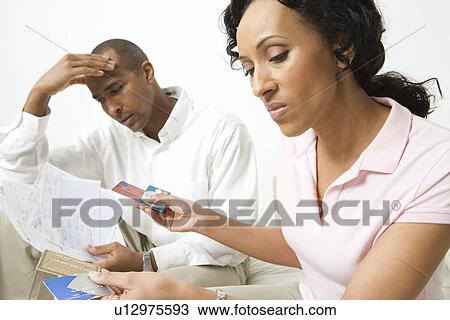 Stock Image - Couple Discussing Credit Card Bills. Fotosearch