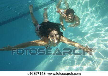 Couple diving in pool, underwater view View Large Photo Image Stock Image - Couple diving in pool, underwater view. Fotosearch
