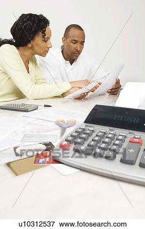 Stock Photo - Couple Doing Finances. Fotosearch