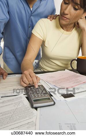 Stock Image - Couple Figuring out Bills. Fotosearch