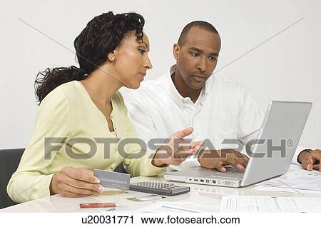 Stock Image - Couple Figuring out Finances. Fotosearch