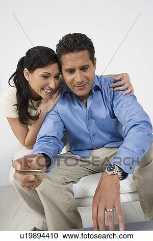 Stock Image - Couple Holding Credit Card. Fotosearch