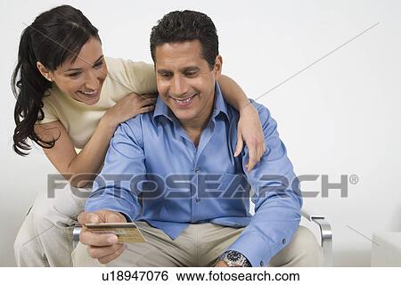 Stock Photograph - Couple Holding Credit Card. Fotosearch