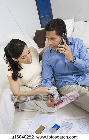 Stock Image - Couple Holding Credit Cards. Fotosearch