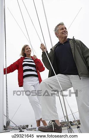 Stock Photography - Couple on yacht, low angle view. Fotosearch
