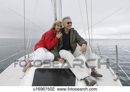 Couple relaxing on yacht View Large Photo Image Stock Image - Couple relaxing on yacht. Fotosearch