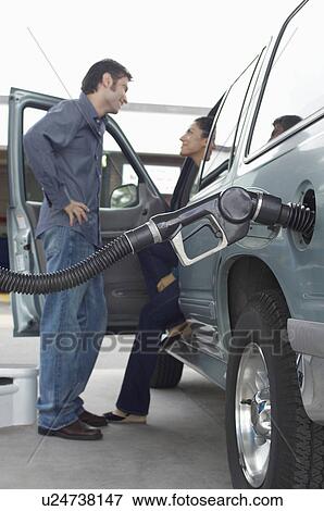 Stock Photo - Couple talking in van with fuel pump in it. Fotosearch