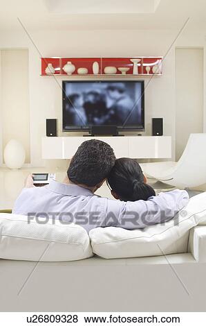 Stock Photo - Couple Watching TV. Fotosearch