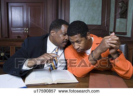 Stock Photo - Criminal with lawyer in court. Fotosearch