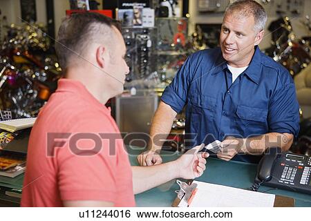 Customer in Motorcycle Shop Paying View Large Photo Image Stock Photograph - Customer in Motorcycle Shop Paying. Fotosearch
