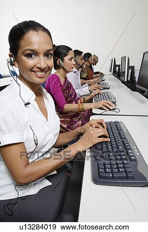 Stock Photo - Customer Service Reps in Call Center. Fotosearch
