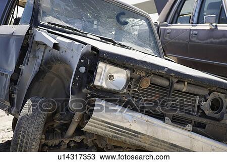 Stock Image - Damaged car in junkyard. Fotosearch