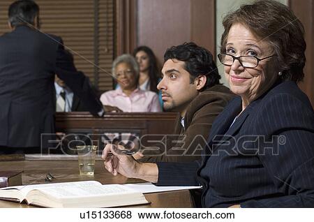 Defense lawyer with client in court View Large Photo Image Stock Photo - Defense lawyer with client in court. Fotosearch