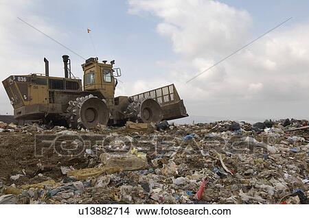 Digger working at landfill site View Large Photo Image Picture - Digger working at landfill site. Fotosearch