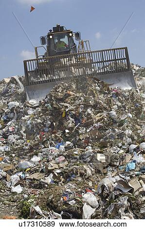 Stock Photo - Digger working at landfill site. Fotosearch