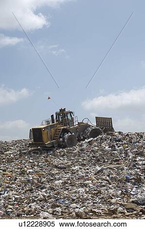 Digger working at landfill site View Large Photo Image Stock Photography - Digger working at landfill site. Fotosearch
