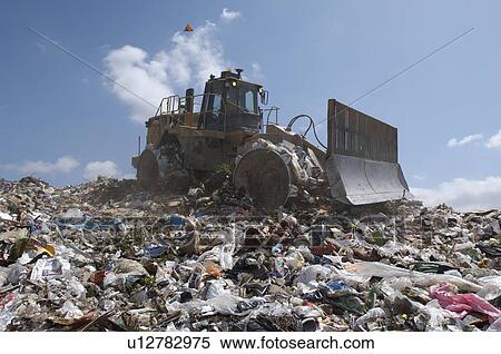 Digger working at landfill site View Large Photo Image Stock Photography - Digger working at landfill site. Fotosearch