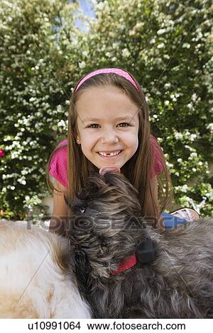 Picture - Dog Licking Little Girl's Chin. Fotosearch