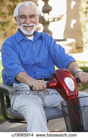 Elderly man on motor scooter View Large Photo Image Picture - Elderly man on motor scooter. Fotosearch