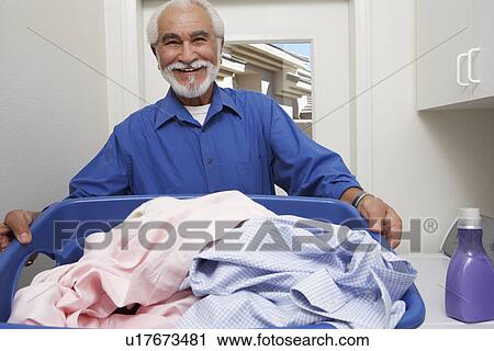 Stock Image - Elderly man with laundry basket. Fotosearch