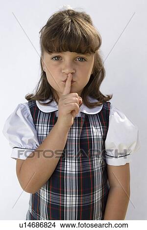 Picture - Elementary Student with Finger on Lips. Fotosearch