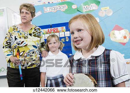 Elementary Student with Tambourine in Music Class View Large Photo Image Stock Photograph - Elementary Student with Tambourine in Music Class. Fotosearch