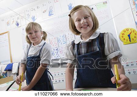 Stock Photograph - Elementary Students Painting During Art Class. Fotosearch