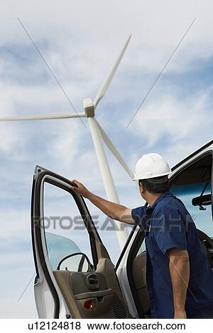 Engineer by car at wind farm View Large Photo Image Stock Photo - Engineer by car at wind farm. Fotosearch