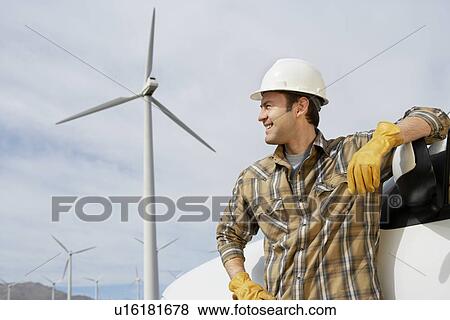 Engineer by car at wind farm View Large Photo Image Stock Photo - Engineer by car at wind farm. Fotosearch