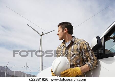 Engineer by car at wind farm View Large Photo Image Stock Photograph - Engineer by car at wind farm. Fotosearch