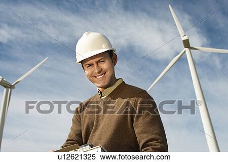 Engineer near wind turbines at wind farm, portrait View Large Photo Image Stock Photography - Engineer near wind turbines at wind farm, portrait. Fotosearch