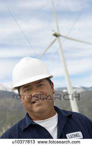 Engineer wearing hardhat at wind farm, portrait View Large Photo Image Stock Image - Engineer wearing hardhat at wind farm, portrait. Fotosearch