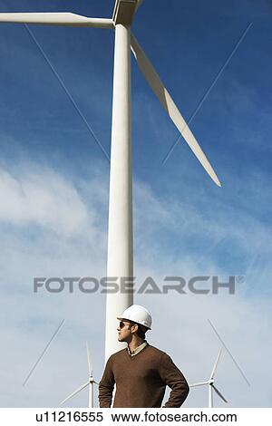Engineer wearing hardhat at wind farm View Large Photo Image Stock Photography - Engineer wearing hardhat at wind farm. Fotosearch