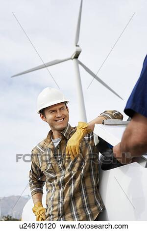 Engineers near wind turbine at wind farm View Large Photo Image Stock Image - Engineers near wind turbine at wind farm. Fotosearch