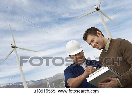 Stock Photography - Engineers working at wind farm. Fotosearch